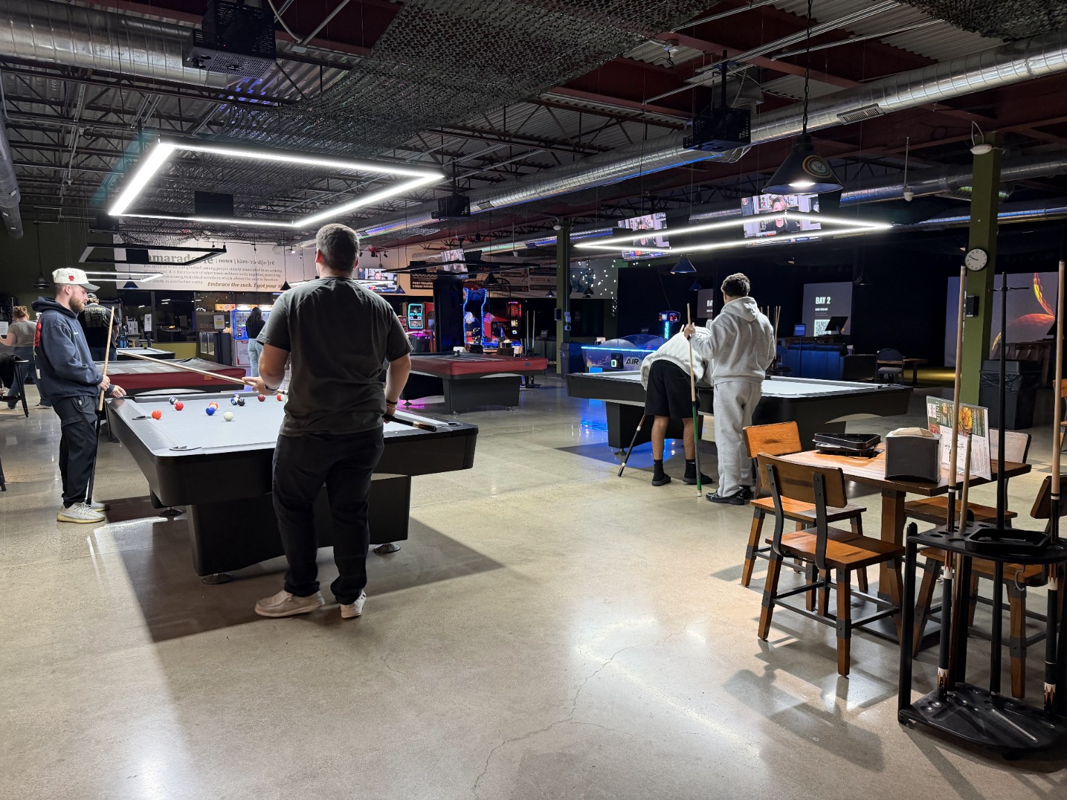Guests playing pool at Canteen Golf & Billiards